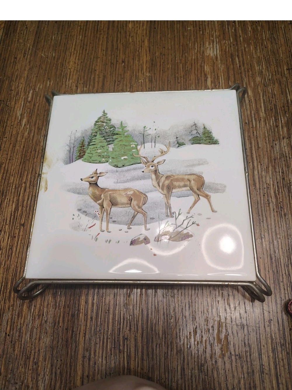vintage ceramic tile trivet featuring a winter landscape with deer